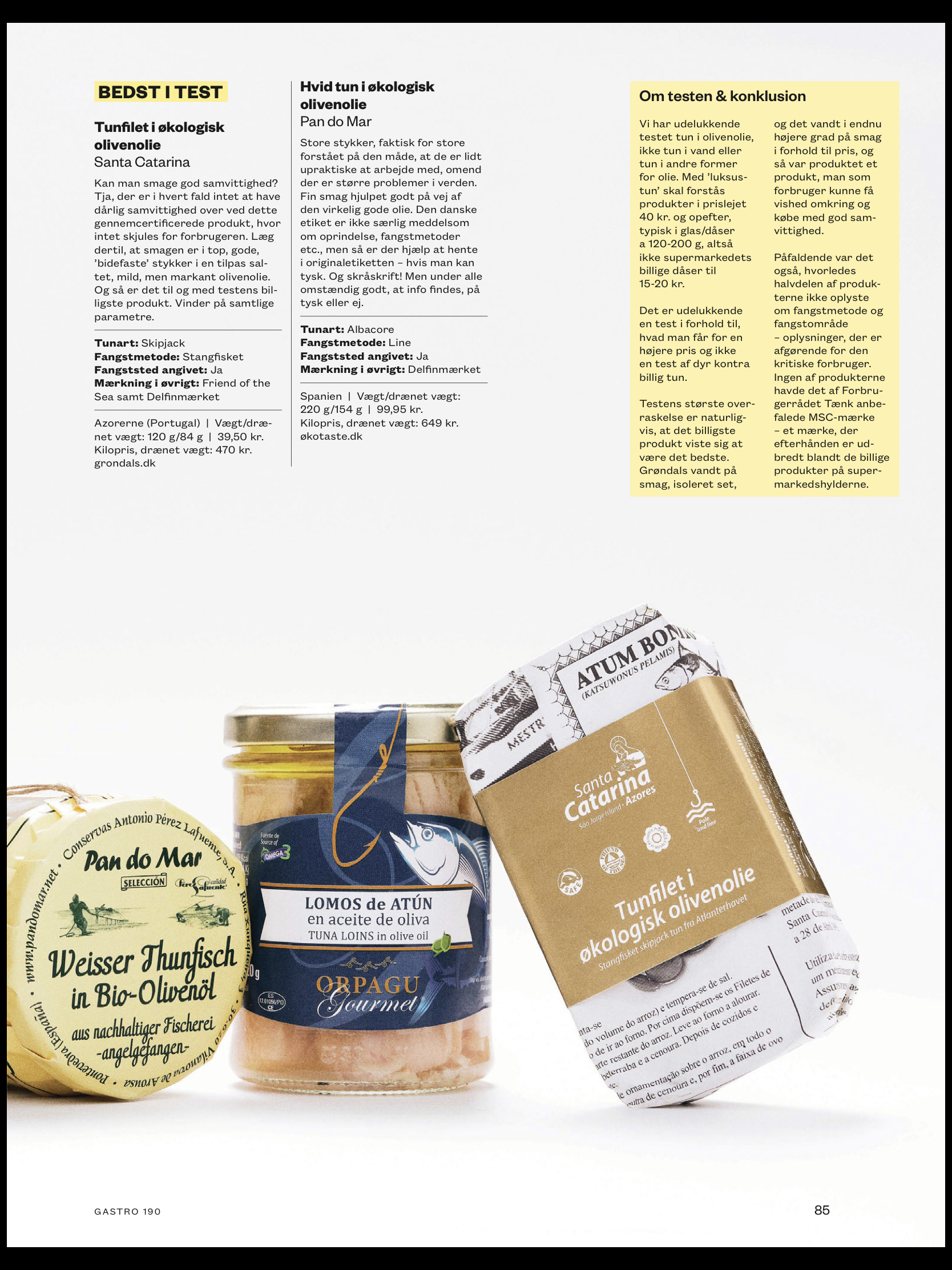 Tre dåser og glas med Santa Catarina Tunfilet i økologisk olivenolie vises på en hvid overflade sammen med en magasinside med dansk tekst, vurderinger og beskrivelser af hvert bæredygtigt tunprodukt ovenover og ved siden af.
